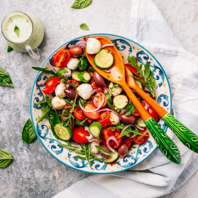 Fresh vegetarian salad with dried and fresh tomatoes, mozzarella and arugula
